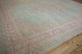 Distressed Oushak carpet's classic book cover corner spandrel in powder blue and soft pink.