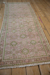 Distressed vintage Hamadan runner showing intricate pink, green Herati pattern and vine border.