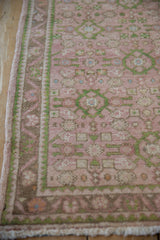 Distressed vintage Hamadan runner in dusty rose and emerald, featuring Herati motif and vine border.