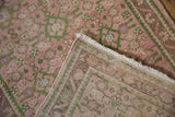 Distressed pink and green Herati floral motif and hand-knotted reverse of a vintage Hamadan runner.