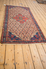 Traditional Hamadan runner with shield medallion, lattice field, and sapphire blue borders.