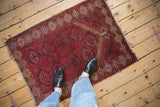 Vintage Beshir rug corner, showing ram's horn guls, red palette, and even pile wear.