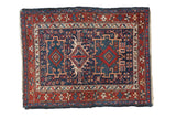 Hand-knotted vintage Karaja rug with mirrored geometric medallions in navy blue, cherry red, and ivory.