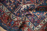 Detailed starburst main border and checkerboard vinery on a vintage Persian Karaja rug.