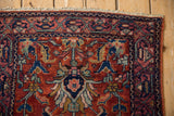 Vintage Lilihan rug fringe and border detail with cherry red field and navy floral design.