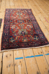 Vintage Lilihan runner: cherry red field with blue palmettes, arabesques, and navy border details.