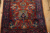 Fine wool pile on a vintage Lilihan rug showcasing cherry red field, dusty blue palmettes, and navy border.
