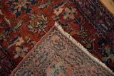 Ornate floral design on deep red vintage Lilihan rug with patterned hand-knotted reverse and fringe.