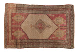 Distressed vintage Kurdish Hamadan rug with dusty red field, geometric medallion, and human figures.