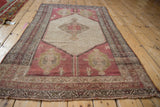 Distressed geometric borders with dusty red, charcoal, and ivory on vintage Hamadan rug.
