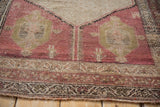 Distressed Kurdish Hamadan rug pile revealing faded dusty cochineal, antique ivory, and geometric motifs.