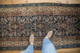 Vintage Hamadan runner with a navy Herati pattern, viewed from above to show its scale and fine texture.