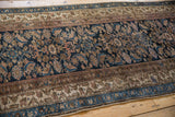 Textured wear on the wool pile across the navy blue Herati motif and detailed triple borders.
