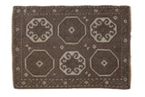 Vintage distressed Oushak rug with octagonal gul medallions in chocolate brown and ivory.
