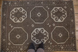 View from above the distressed Oushak's brown and ivory octagonal medallions.