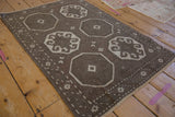 Angled view showcasing the distressed Oushak rug's geometric medallion pattern.