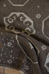 A soft fold in the distressed Turkish rug reveals its even, low wool pile.