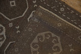 Reverse view of a vintage Oushak rug showing its hand-knotted foundation and intact side cord.