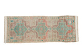 Distressed Oushak rug runner with triple geometric medallions, starburst motifs, and muted teal, mauve, ivory hues, 1'10