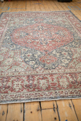 Vintage distressed Sparta carpet section with madder red floral motifs and faded slate.