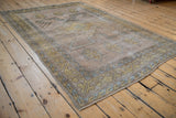 Primitive geometric gold and dusty blue border on distressed Melas rug with intact selvage.