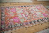 Vintage Oushak rug with decorative wear, showcasing tangerine and hot pink floral bouquets.