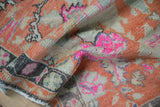 Worn, hand-knotted pile of a vintage Oushak rug showing vibrant hot pink and tangerine details.