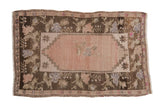 Vintage Distressed Oushak rug with blush field, charcoal floral border, stepped corners; 2'8