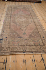 Textured distressed Oushak runner pile with faded dusty rose, beige, and teal abrash.