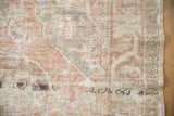 Visible foundation and texture of a distressed Oushak rug, with dusty rose, beige, and slate blue.
