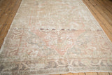 Distressed Oushak carpet's worn pile, showing foundation and faded dusty rose and beige tones.