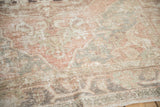 Distressed Oushak rug texture revealing visible foundation in dusty rose and beige.