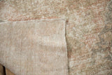 Distressed Oushak rug pile with visible foundation, woven backing, and intact selvage.