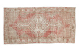 Vintage distressed Oushak runner with a stepped diamond medallion in pale raspberry rose and ivory.
