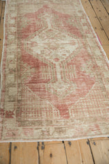 Low angle perspective of a vintage Oushak runner highlighting its time-softened texture.