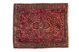 Vintage American Sarouk square rug with a millefleur floral design in cherry red and deep navy blue.