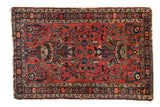 Vintage Persian Lilihan rug with a double vase floral motif on a raspberry red field.