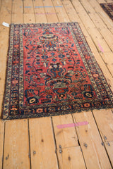 Side angle view of the vintage Lilihan rug's traditional Persian vase and plant motif.