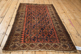 Vintage Belouch runner, geometric chocolate brown, terracotta, navy pattern detail, showing edge tatter.