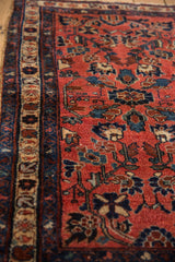 Angled view of the fine wool pile on a vintage Mehreban rug with blue palmettes on a raspberry field.