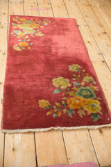 Dusty raspberry red field with saffron and jade floral Art Deco motifs.
