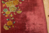 Nichols Art Deco rug, showing cochineal red field with varied pile and saffron, jade floral motifs.