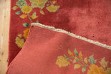 Dusty red pile of Art Deco rug with subtle moth nibbles and fringe detail.