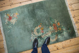 Vintage Nichols Art Deco rug, sage green field with eucalyptus blossoms, showing scale.