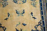 Vintage Peking rug's cream field, cobalt blue butterflies, blossoms, geometric border, and patina.
