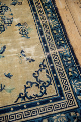 Vintage Peking rug corner, cobalt blue Greek key main border, faded cream field.