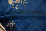 Plush navy blue pile of the vintage Chinese Peking rug with beige floral branches.