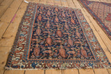 Vintage Fine Mehreban rug corner detail, ivory border, geometric motifs, tattered ends.