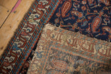 Vintage Mehreban rug reverse, showing hand-knotted foundation and tattered red-blue border.