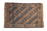Vintage hand-knotted Persian Belouch rug displaying beige and blue diamond lattice, visible wear, 2'4